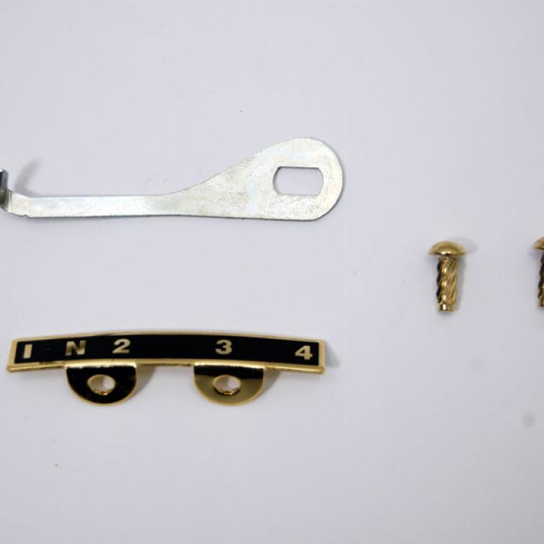 Pre unit gear indicator plate assembly with arms & rivets